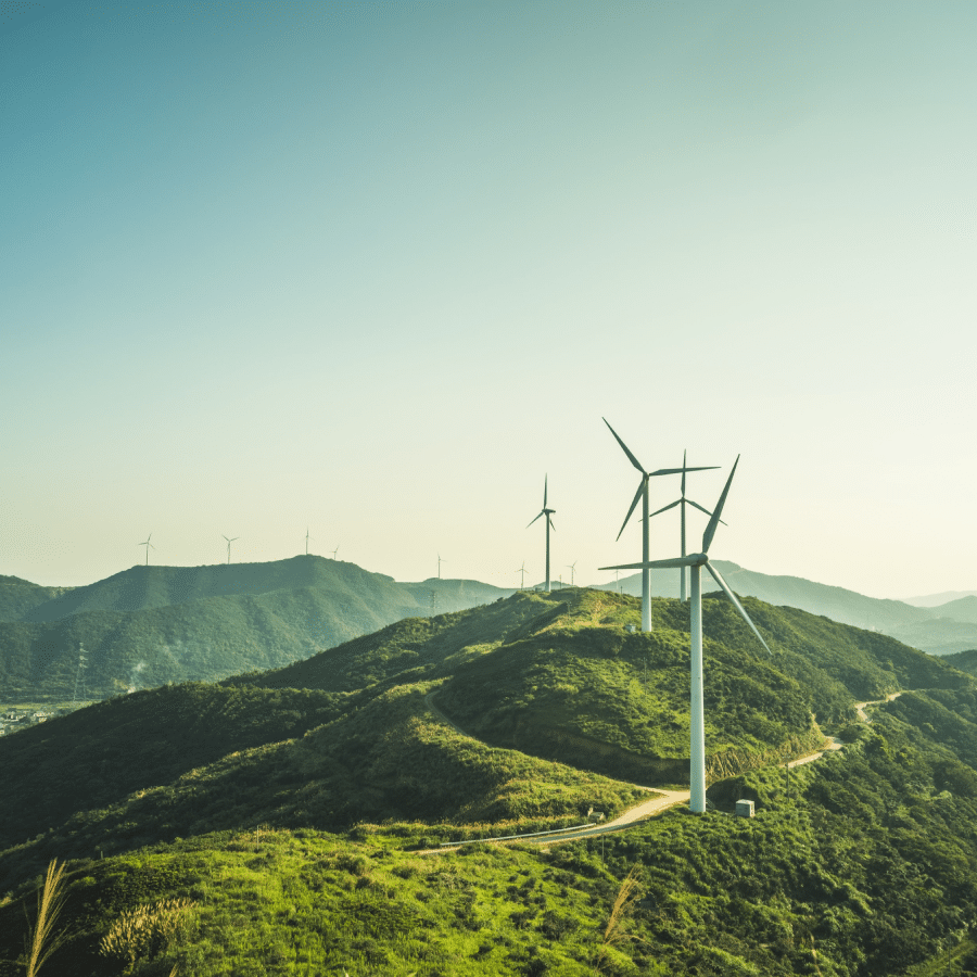 Photo of a group of turbines on lush green mountains